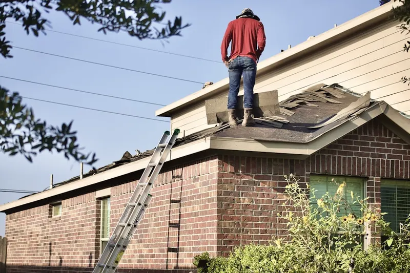 Professional roofer working on a residential roof in Canterwood